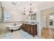 A luxurious bathroom features a soaking tub, dual vanity, modern fixtures, and stylish decor at 1336 51St Ne Ave, St Petersburg, FL 33703