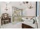 An elegant bathroom features a soaking tub, glass shower, and dual vanity with custom cabinetry at 1336 51St Ne Ave, St Petersburg, FL 33703