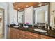 Bathroom features dual sinks, granite counters, and decorative mirrors for a luxurious feel at 1336 51St Ne Ave, St Petersburg, FL 33703