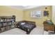 Bright bedroom with a cozy bed, a neutral color scheme, soft carpeting, and window shutters at 1336 51St Ne Ave, St Petersburg, FL 33703