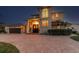 Exterior of home featuring a circular driveway and well-maintained landscaping at 1336 51St Ne Ave, St Petersburg, FL 33703