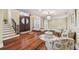 Well-lit foyer with hardwood floors, a compass rose inlay, and an elegant staircase at 1336 51St Ne Ave, St Petersburg, FL 33703
