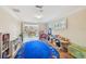 Bright playroom with French doors, a blue alphabet rug, and an abundance of toys and storage at 1336 51St Ne Ave, St Petersburg, FL 33703