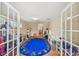This spacious playroom features a large oval rug, tile floors, and plenty of storage for toys and books at 1336 51St Ne Ave, St Petersburg, FL 33703