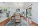Dining area showcasing an elegant table setting, stylish rug, and sliding glass doors to the patio at 212 Arbor Woods Cir, Oldsmar, FL 34677