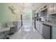 Bright kitchen featuring white cabinets, stainless steel appliances, and sleek marble floors at 212 Arbor Woods Cir, Oldsmar, FL 34677