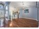 Bright living room featuring hardwood floors, modern lighting, and an arched entry to the kitchen at 212 Arbor Woods Cir, Oldsmar, FL 34677