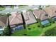 Aerial view of luxurious homes with tile roofs and screened-in pools, surrounded by green landscaping at 21807 Amelia Rose Way, Land O Lakes, FL 34637