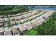 Aerial view showcasing neighborhood homes situated near a beautiful lake and lush greenery at 21807 Amelia Rose Way, Land O Lakes, FL 34637