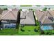 An aerial view shows the tile roof and screened-in pools of these houses in a planned community at 21807 Amelia Rose Way, Land O Lakes, FL 34637