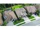 Aerial view showcasing home's roof, landscaping, proximity to water and neighborhood at 21807 Amelia Rose Way, Land O Lakes, FL 34637