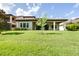 Lush backyard featuring mature trees, a covered patio, and a spacious lawn at 21807 Amelia Rose Way, Land O Lakes, FL 34637
