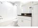 Bright bathroom features a shower over tub, granite counter, and white cabinets at 21807 Amelia Rose Way, Land O Lakes, FL 34637