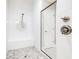 Modern bathroom features tiled shower with glass door and mosaic floor at 21807 Amelia Rose Way, Land O Lakes, FL 34637