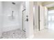 Modern bathroom features tiled shower with glass door and mosaic floor at 21807 Amelia Rose Way, Land O Lakes, FL 34637
