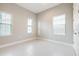 Bedroom features three windows and neutral walls at 21807 Amelia Rose Way, Land O Lakes, FL 34637