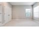 Bedroom with neutral walls, light carpet, and double door closet at 21807 Amelia Rose Way, Land O Lakes, FL 34637