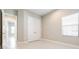Bedroom featuring double door closet, a window, and neutral walls at 21807 Amelia Rose Way, Land O Lakes, FL 34637