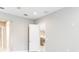 Bright bedroom features neutral walls, white trim, and a closed white door at 21807 Amelia Rose Way, Land O Lakes, FL 34637