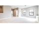 Spacious bonus room with soft carpet, two large windows, and neutral paint at 21807 Amelia Rose Way, Land O Lakes, FL 34637