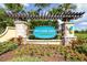 Community entrance with Pristine Lake Preserve sign, stone pillars and beautiful landscaping at 21807 Amelia Rose Way, Land O Lakes, FL 34637