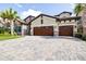 Beautiful home with a two-car garage, paver driveway, and tropical landscaping at 21807 Amelia Rose Way, Land O Lakes, FL 34637