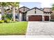 Charming single-Gathering home with a well-manicured lawn, stone facade, and a three-car garage at 21807 Amelia Rose Way, Land O Lakes, FL 34637