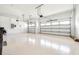 Spacious three car garage with epoxy flooring and two garage doors at 21807 Amelia Rose Way, Land O Lakes, FL 34637