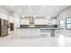 Spacious kitchen with stainless steel appliances, a large island, and sleek white cabinets at 21807 Amelia Rose Way, Land O Lakes, FL 34637