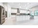 Large, bright kitchen featuring stainless steel appliances, island, and tile floors at 21807 Amelia Rose Way, Land O Lakes, FL 34637