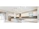 Spacious kitchen featuring white cabinetry, an island, stainless steel appliances, and modern finishes at 21807 Amelia Rose Way, Land O Lakes, FL 34637