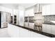 Kitchen island with granite countertop, stainless steel appliances, and white cabinets at 21807 Amelia Rose Way, Land O Lakes, FL 34637