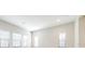 Bright living room showcasing neutral walls and light-filled windows with modern blinds at 21807 Amelia Rose Way, Land O Lakes, FL 34637