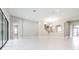 Open floor plan of the living room with arched entryway and tile flooring at 21807 Amelia Rose Way, Land O Lakes, FL 34637