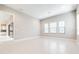 Large living room with tile flooring, modern lighting, and view to the kitchen at 21807 Amelia Rose Way, Land O Lakes, FL 34637