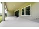 Covered patio featuring sleek concrete flooring, recessed lights, and sliding glass doors at 21807 Amelia Rose Way, Land O Lakes, FL 34637