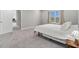 This bedroom offers a spacious layout with a large window and neutral carpet flooring at 22990 Scaglione Dr, Lutz, FL 33549