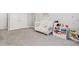 Charming Bedroom featuring playful wall decor, a crib, and toy storage at 22990 Scaglione Dr, Lutz, FL 33549