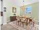 A dining area features a wooden table with seating for six, complemented by a decorative cabinet and natural light at 22990 Scaglione Dr, Lutz, FL 33549