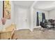 Entryway with light gray walls and a view of a gaming room through an open doorway at 22990 Scaglione Dr, Lutz, FL 33549