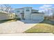 Beautiful two-story home featuring a three-car garage and large paver driveway at 22990 Scaglione Dr, Lutz, FL 33549