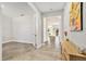 Hallway featuring neutral colors, tile flooring, and natural light, leading to various rooms in the home at 22990 Scaglione Dr, Lutz, FL 33549