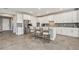 The kitchen is equipped with stainless steel appliances, white cabinetry, and a large island with bar seating at 22990 Scaglione Dr, Lutz, FL 33549
