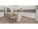 Kitchen with stainless steel appliances, white cabinetry, and a large island with bar seating at 22990 Scaglione Dr, Lutz, FL 33549