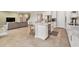 A stylish kitchen with an island, stone countertops and stainless steel appliances open to the living area at 22990 Scaglione Dr, Lutz, FL 33549