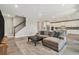 Living room with stairway adjacent to large couch at 22990 Scaglione Dr, Lutz, FL 33549