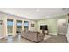 Bright living room with large windows, neutral colors, a comfortable sofa, and stylish decor at 22990 Scaglione Dr, Lutz, FL 33549