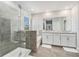 This bathroom features a glass enclosed shower, soaking tub, and double sink vanity at 22990 Scaglione Dr, Lutz, FL 33549
