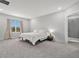 Spacious main bedroom featuring a large window with natural light, neutral tones, and an en-suite bathroom at 22990 Scaglione Dr, Lutz, FL 33549