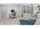 Bright home office with a large window providing natural light and comfortable seating space at 22990 Scaglione Dr, Lutz, FL 33549